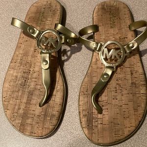 Michael Kors gold flip flops. Cork like inside. Never worn. Excellent condition